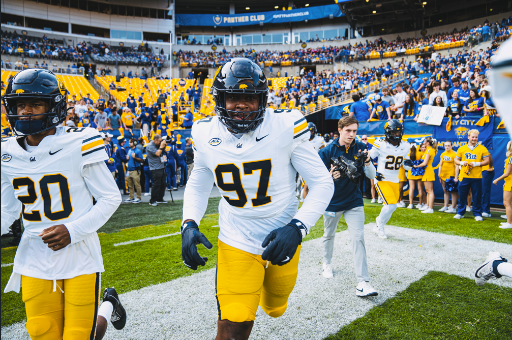 Cal linebacker Michael-Anthony Okwura running onto the field