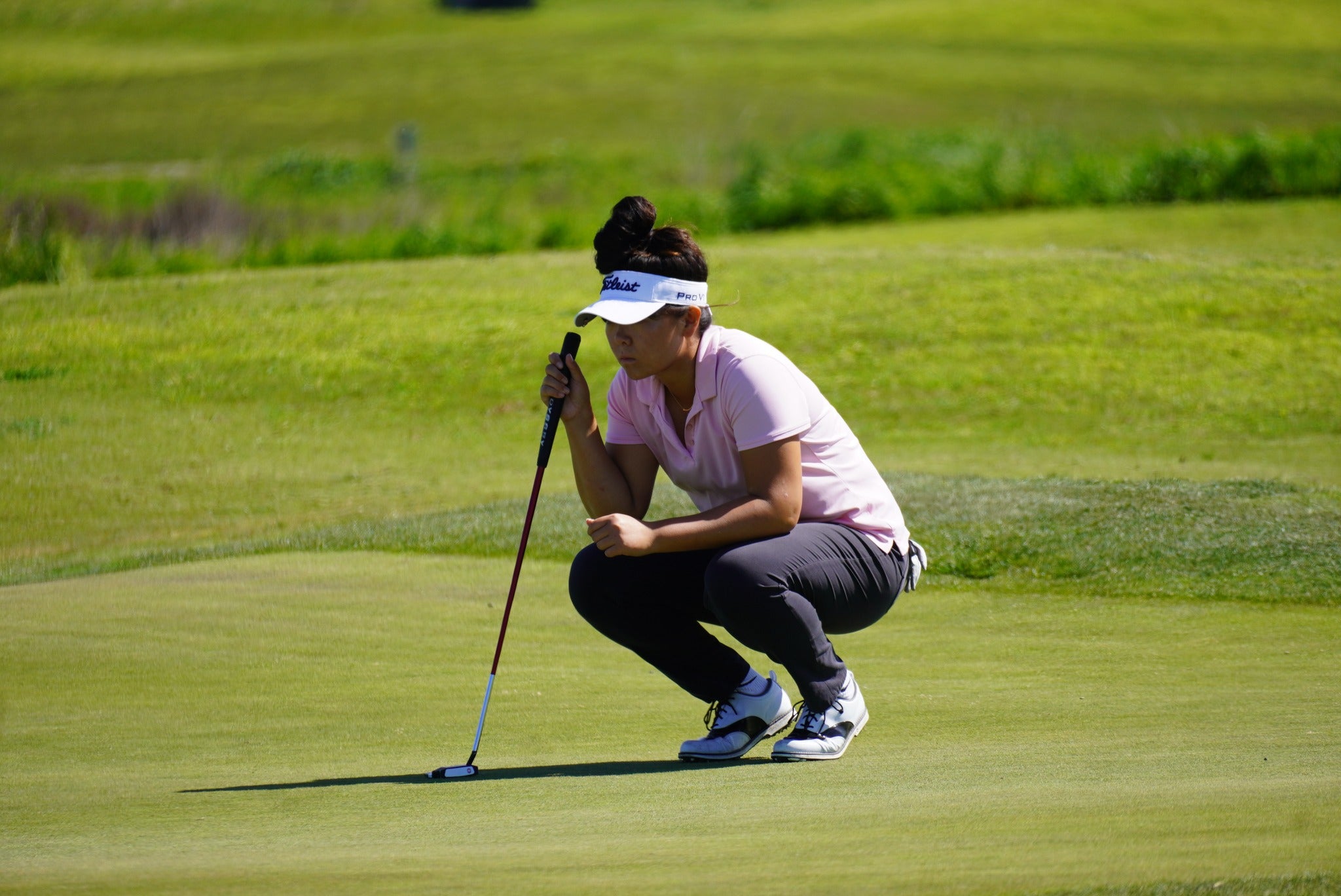 Posana athlete and UC Davis golfer Jade Bai watching her golf ball land